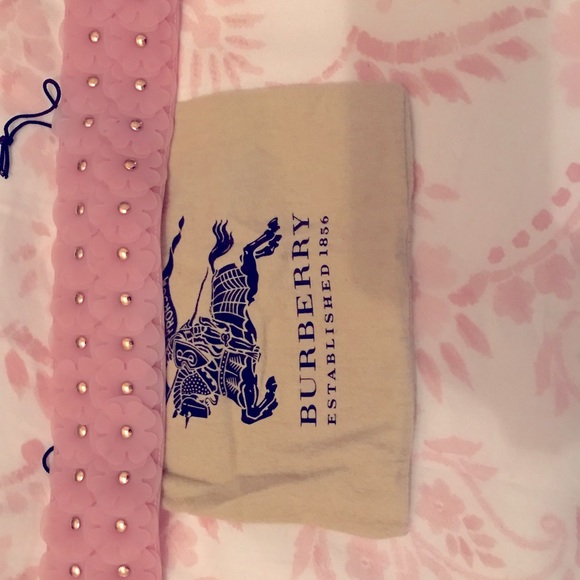 Like new in bag without tag, light pink plastic belt with appliqué flowers